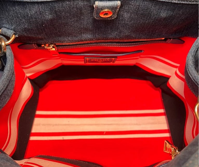 Interior of the bag — red lining with a zipped pocket and the leather PRADA tag