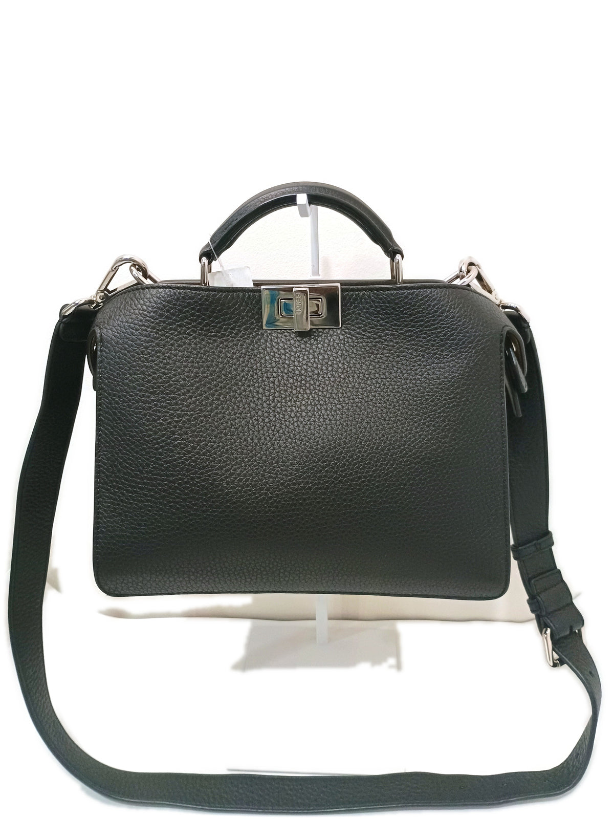 Fendi Peekaboo in black grained calfskin, front view with the engraved palladium twist lock and detachable strap