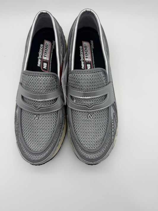 Top-down view of both loafers, silver mesh upper with penny strap