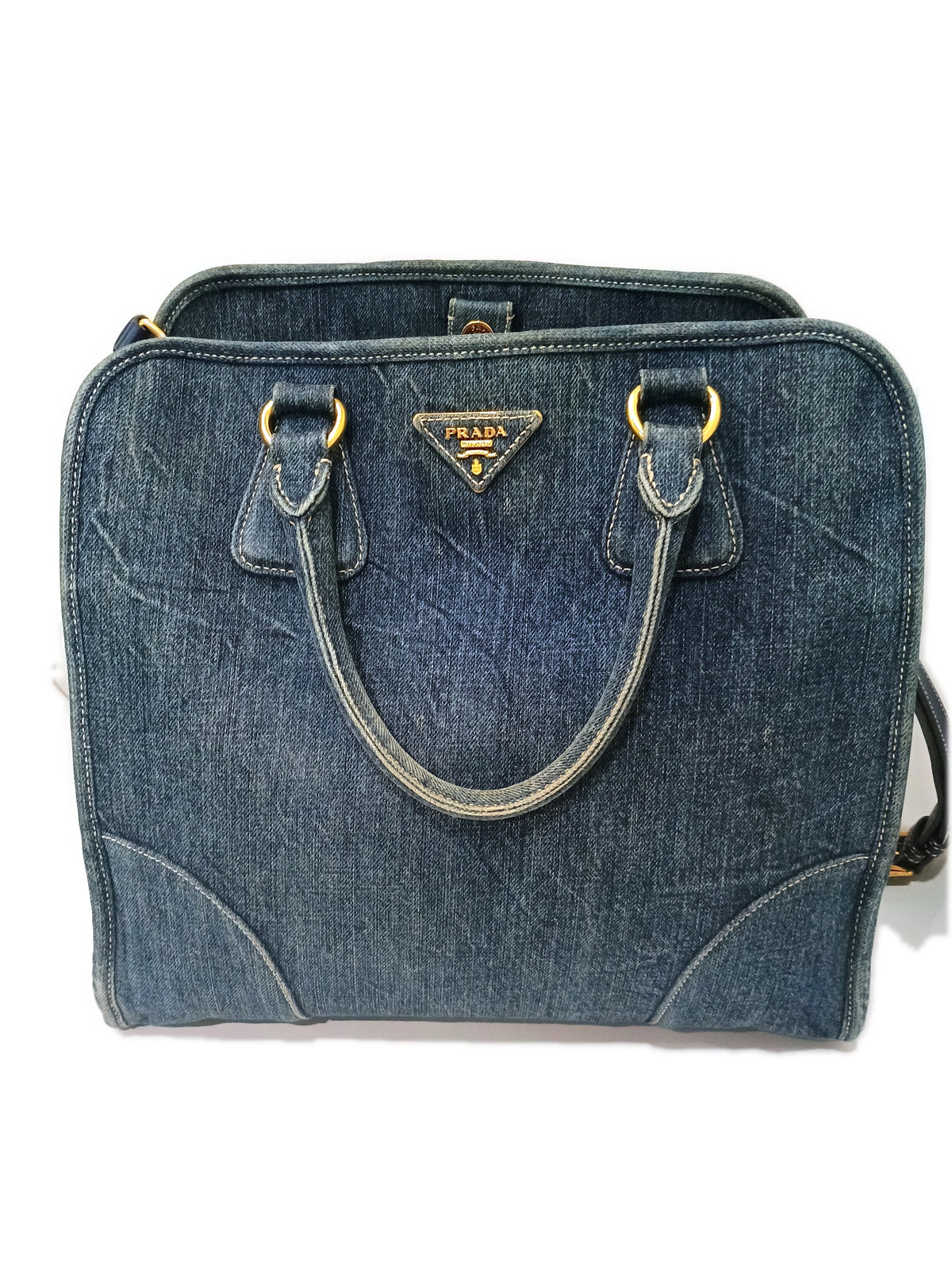 Front of the Prada denim bag showing the contrast topstitching and rounded corner panels