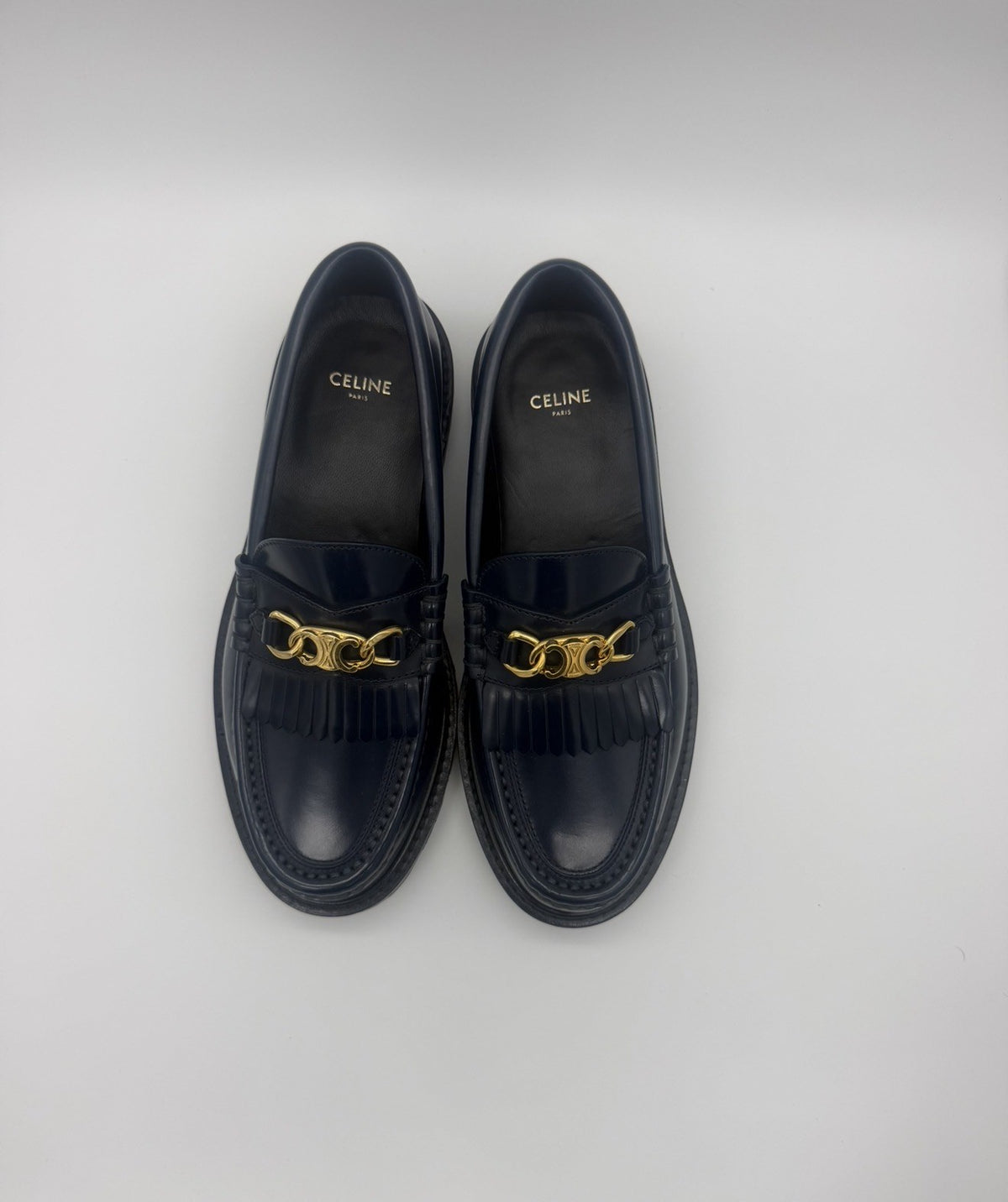 Top-down view of both loafers with the gold CELINE PARIS insole stamp visible
