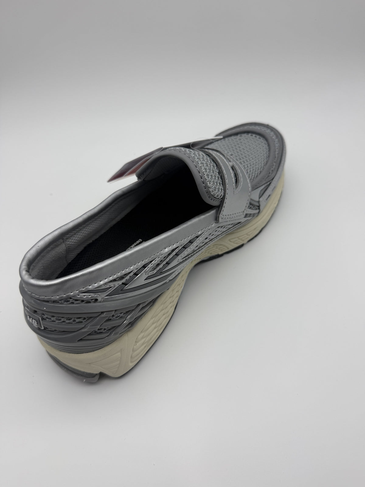 Three-quarter view of the right loafer showing the collapsed heel