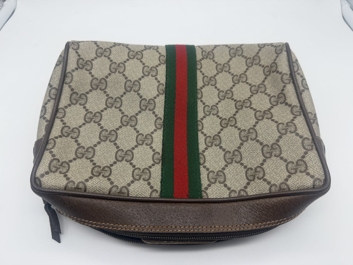 The pouch laid flat, showing the brown leather zip trim, tan double stitching and leather pull tab
