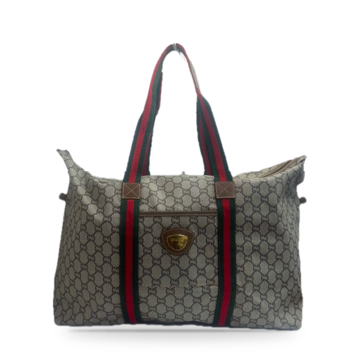 Front of the tote showing the leather-trimmed slip pocket and cross-stitched handle tabs