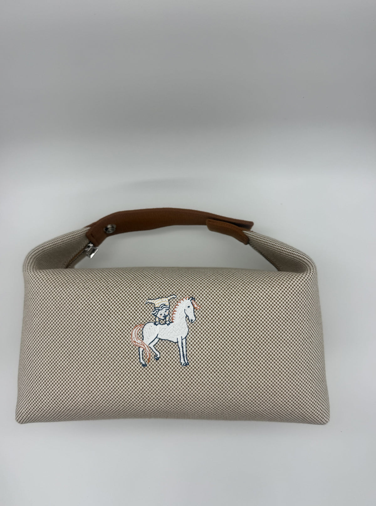 Front elevation showing the embroidered horse and the canvas weave