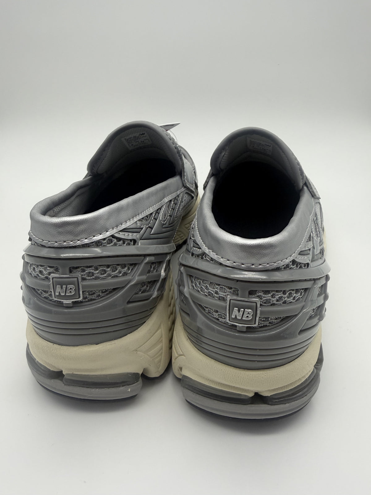 Rear view of both loafers showing the TPU heel cage and cream midsole