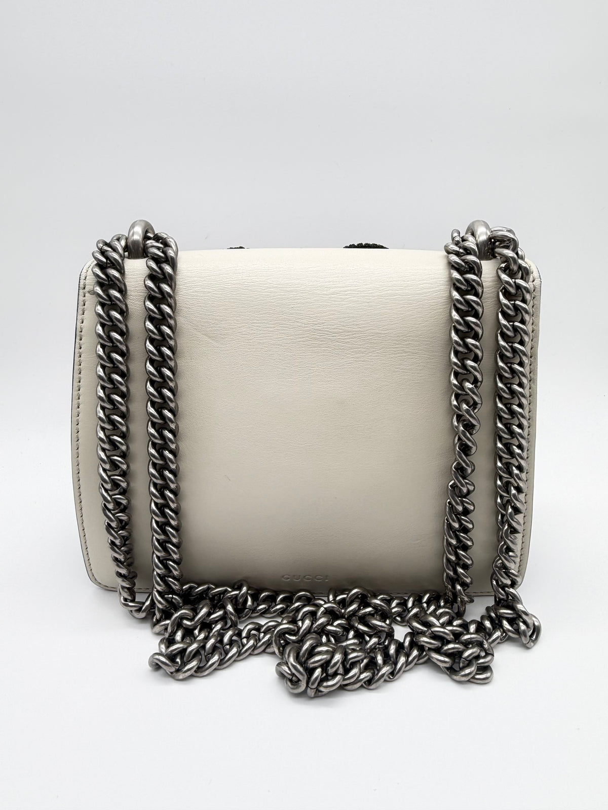 Back of the bag in ivory calfskin with the embossed GUCCI logo