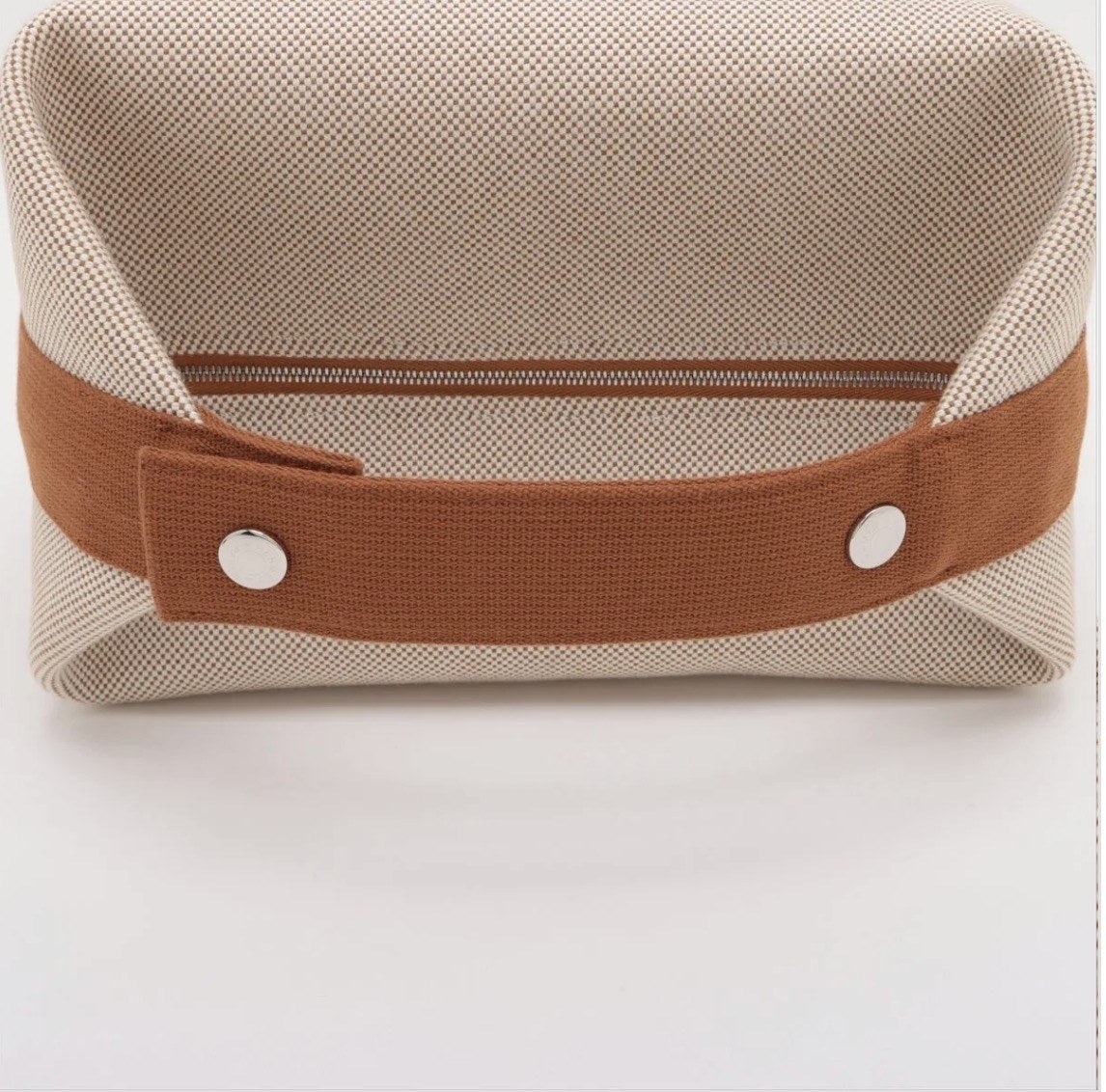 Rear view showing the strap, snap studs and full-length zip