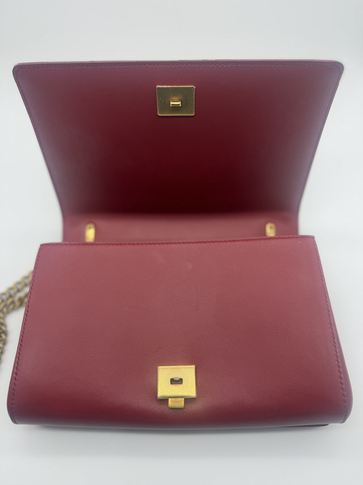Bag open, showing the turn-lock and red leather interior