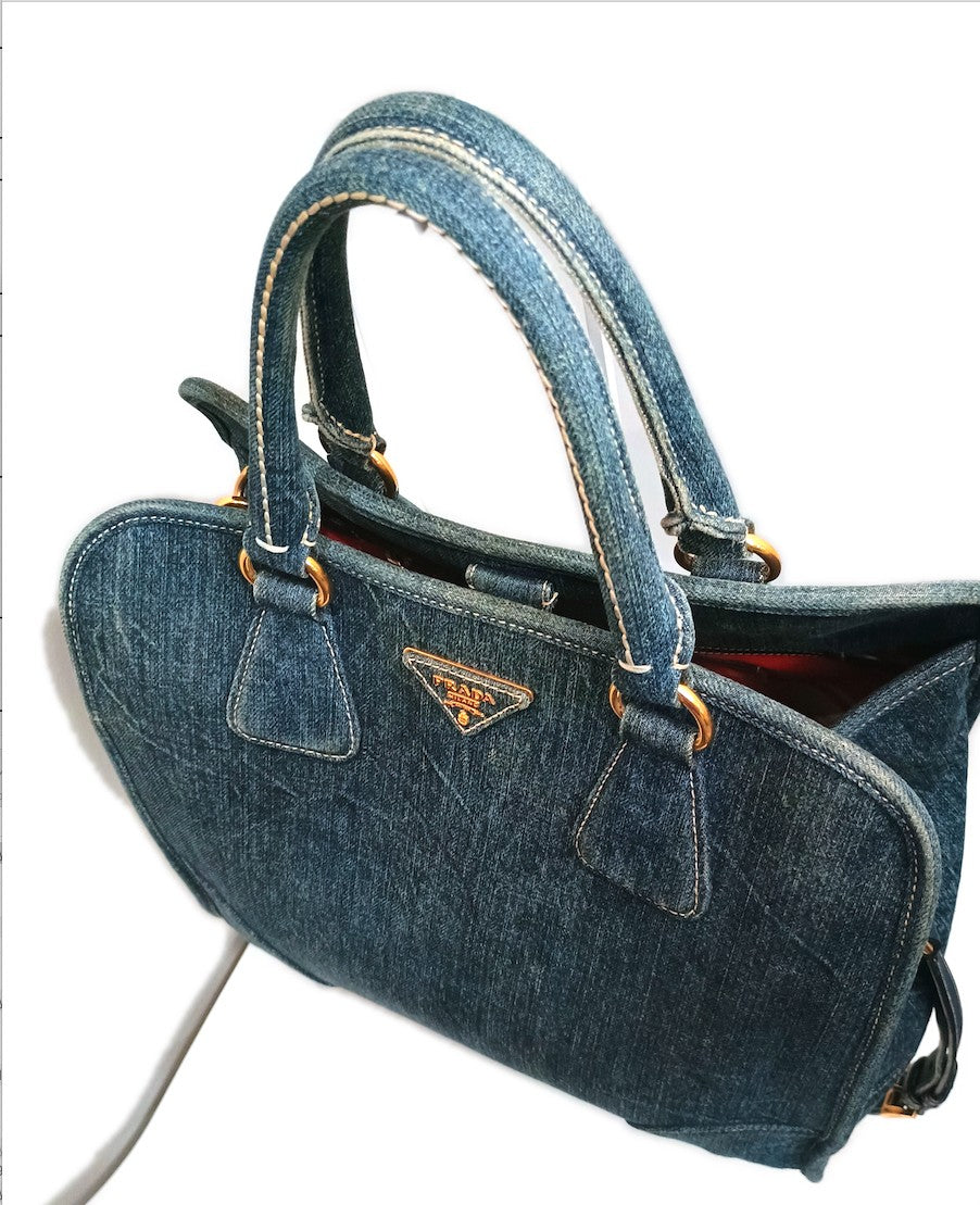 Three-quarter view showing the gusset depth and the gold D-rings