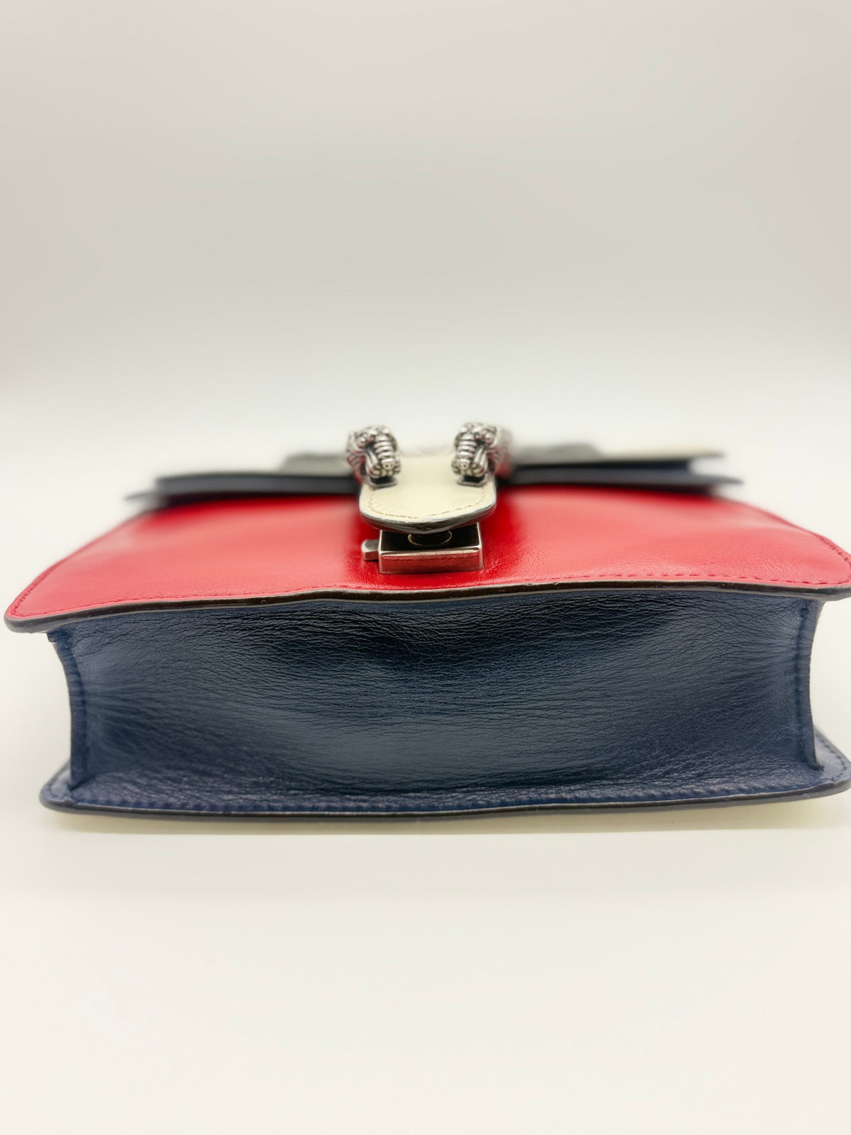 Base of the bag showing the navy leather and corner edges