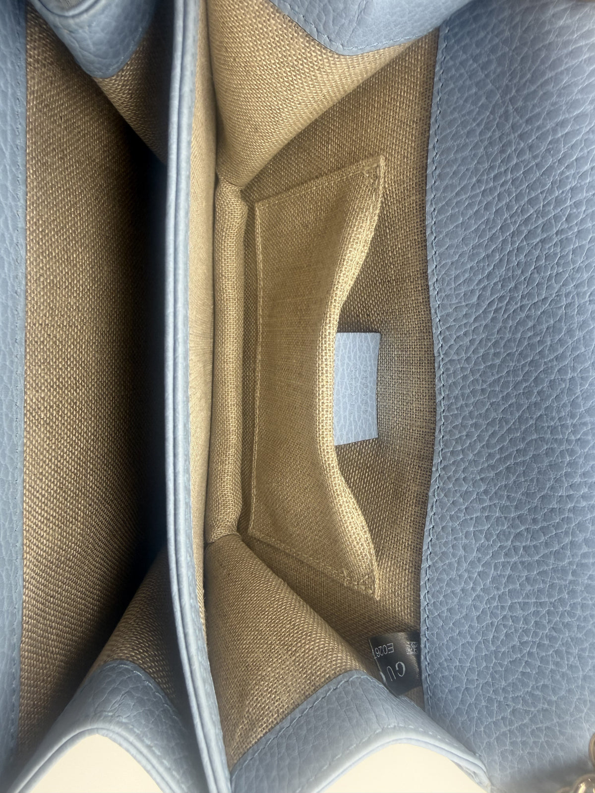 Interior of the Gucci Interlocking GG Small — clean beige canvas lining with slip pocket