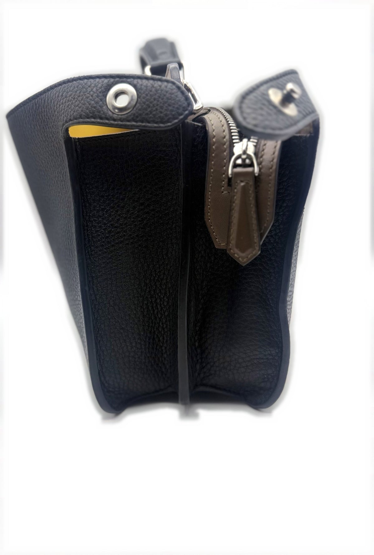 Side profile showing the frame, zip compartment and gusset depth