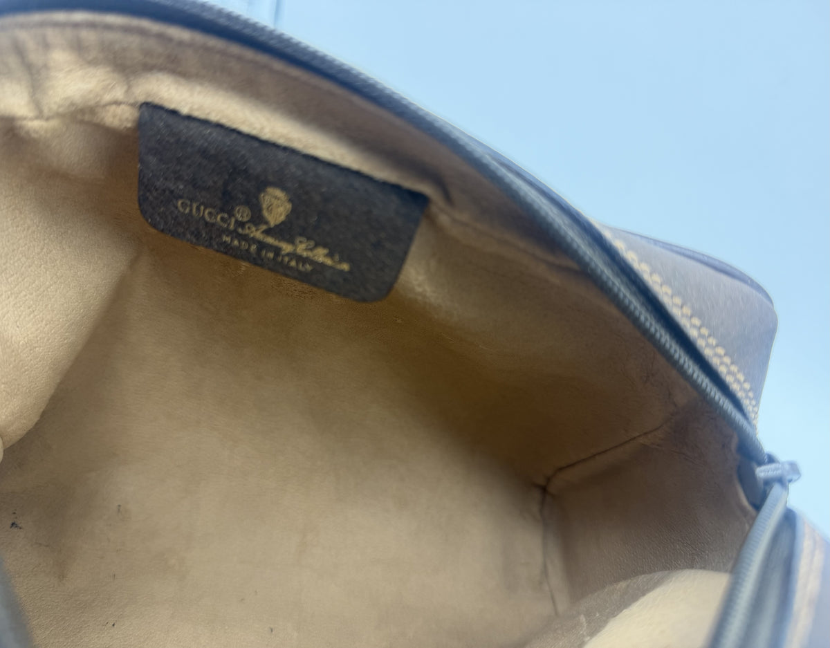 Close view of the GUCCI Accessory Collection leather tag inside the pouch