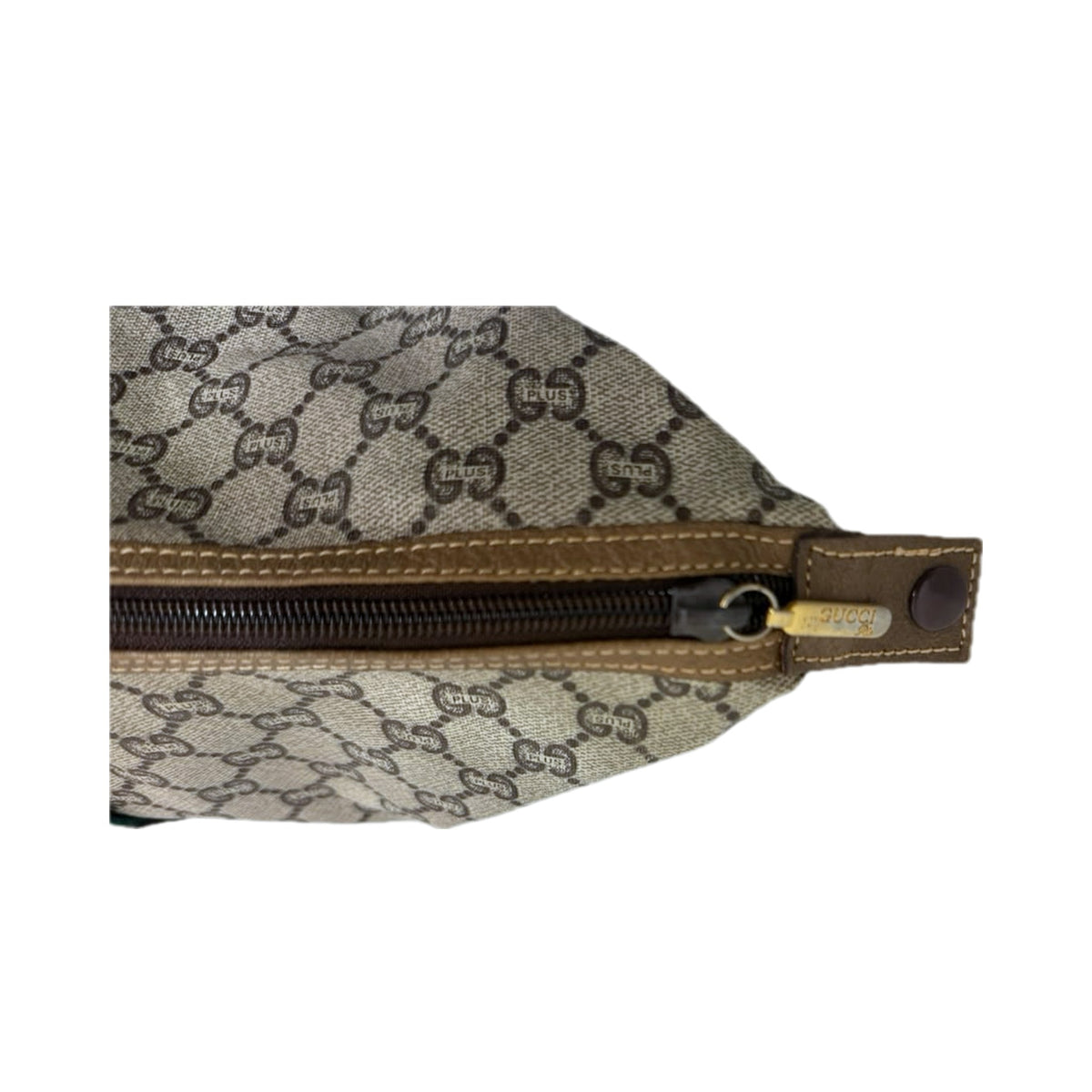 The leather-trimmed top zip with the GUCCI-engraved pull and snap tab