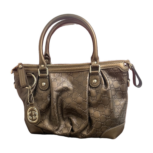 Gucci Sukey in metallic bronze Guccissima calfskin, front view with rolled top handles, light gold hardware and interlocking GG charm